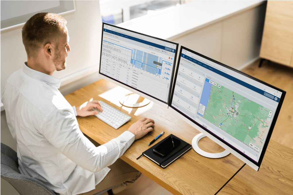 Fleet manager working in the Blue Ink Tech web portal reviewing ELD logbooks and managing alerts on the dashboard